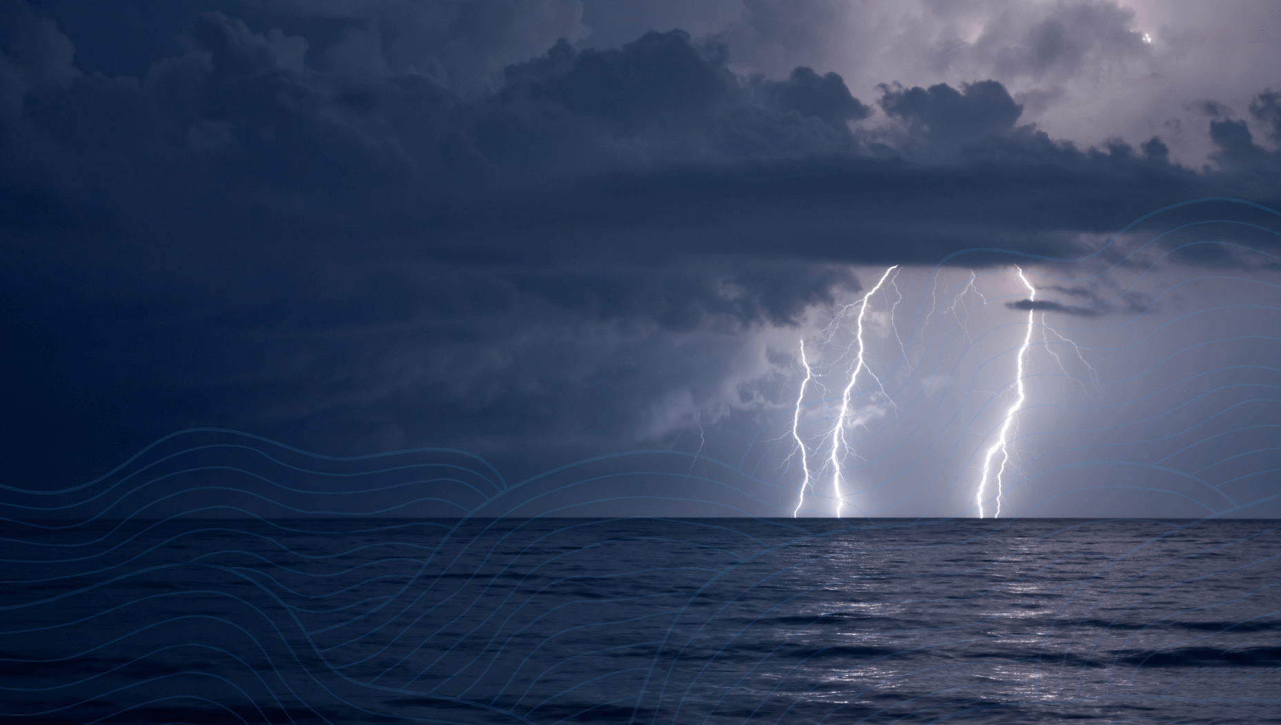 a cloudy dark sky with lightning hitting the ocean in the distance