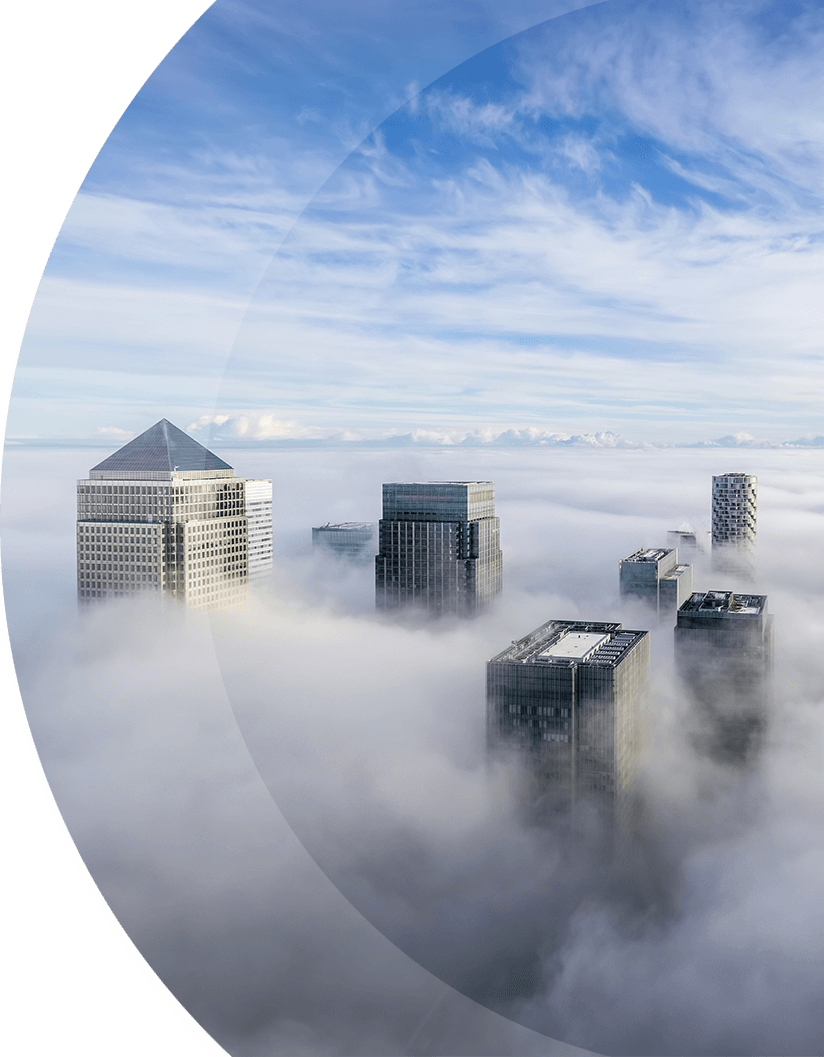 a curved image featuring skyscrapers peeking above the clouds